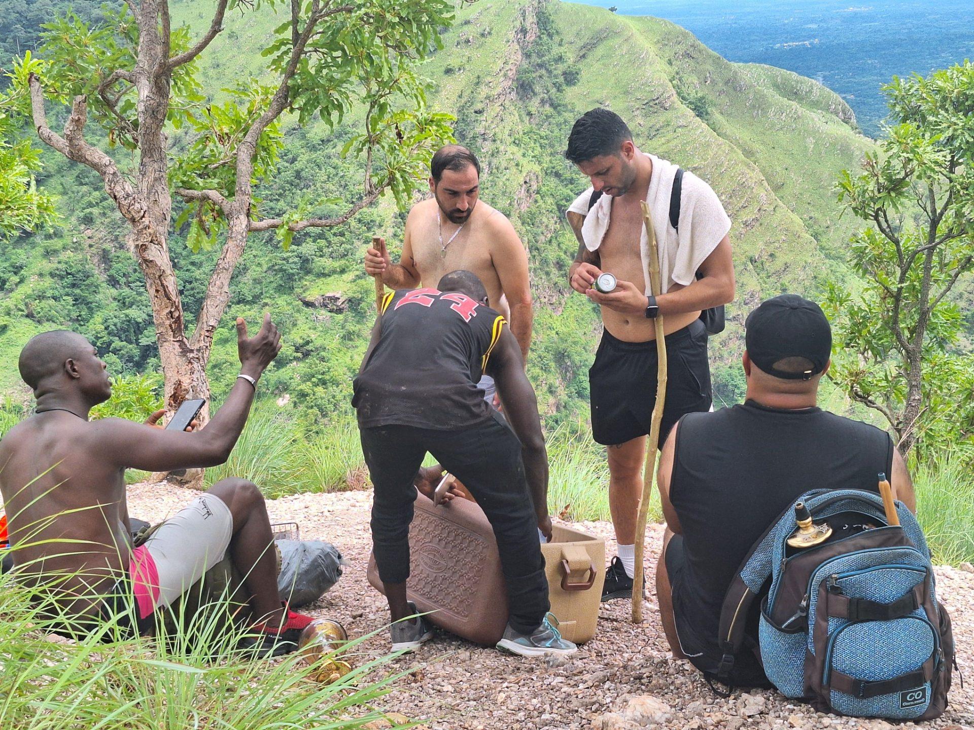 Group of travelers hiking to discover Yikpa Waterfall (Wli Agoummatsa)